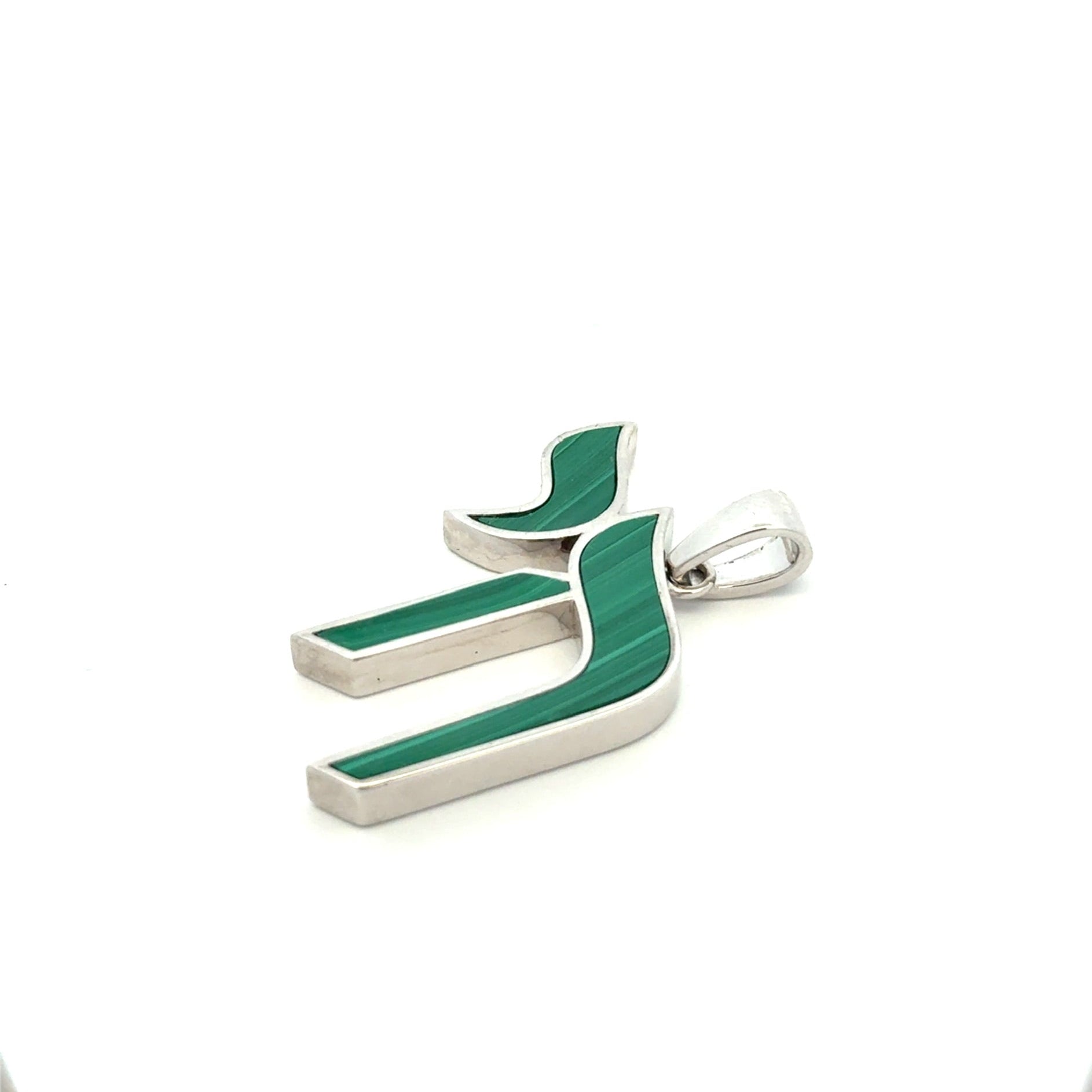 Green and silver pendant on a white background